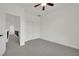 Bright bedroom with carpet flooring, ceiling fan, closet, and hallway access at 3221 Birdwatcher Ave, North Las Vegas, NV 89084