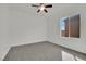 Well-lit bedroom featuring a ceiling fan, a large window, and carpet at 3221 Birdwatcher Ave, North Las Vegas, NV 89084