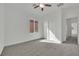 Bedroom with a ceiling fan, closet, large window, and carpet flooring at 3221 Birdwatcher Ave, North Las Vegas, NV 89084