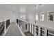 Well-lit hallway with high ceilings, large windows, and decorative railing at 3221 Birdwatcher Ave, North Las Vegas, NV 89084