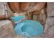 Hot tub covered by a rock grotto feature in the backyard at 3221 Birdwatcher Ave, North Las Vegas, NV 89084