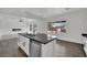 Kitchen island with stainless steel dishwasher, sink and modern faucet, with views to the living area and landscaped backyard at 3221 Birdwatcher Ave, North Las Vegas, NV 89084