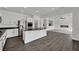 Modern kitchen features stainless steel appliances, granite countertops, and an open layout leading into the living area at 3221 Birdwatcher Ave, North Las Vegas, NV 89084
