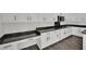 Wide shot of kitchen with white cabinets, long countertops and plank floors at 3221 Birdwatcher Ave, North Las Vegas, NV 89084