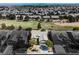 An aerial view of single-story home with desert landscaping and golf course, set within a suburban neighborhood at 3405 Kingbird Dr, North Las Vegas, NV 89084