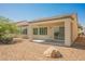 Covered patio and low-maintenance desert landscaping make this backyard ideal for relaxing or entertaining at 3405 Kingbird Dr, North Las Vegas, NV 89084