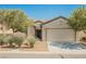Charming single-story home with a two-car garage and well-maintained desert landscaping at 3405 Kingbird Dr, North Las Vegas, NV 89084