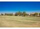 Expansive golf course view showcasing lush green grass and mature trees against a clear blue sky at 3405 Kingbird Dr, North Las Vegas, NV 89084