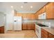 Bright kitchen equipped with stainless steel appliances, wooden cabinets, and a functional layout at 3405 Kingbird Dr, North Las Vegas, NV 89084