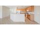Open kitchen featuring wooden cabinetry, modern appliances, and tile flooring, perfect for cooking and entertaining at 3405 Kingbird Dr, North Las Vegas, NV 89084