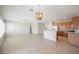 Spacious open-concept living area featuring neutral walls, tile floors, and a kitchen with wooden cabinets at 3405 Kingbird Dr, North Las Vegas, NV 89084