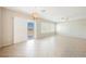 Bright living area with tile flooring, fan, modern chandelier and access to outdoor patio at 3405 Kingbird Dr, North Las Vegas, NV 89084