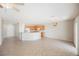 Open living space with tile floors, modern lighting, and seamlessly connected to the kitchen with wooden cabinets at 3405 Kingbird Dr, North Las Vegas, NV 89084