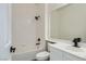 Bathroom with white vanity, white tiled walls in shower, and modern black faucet at 3820 Wiggins Bay St # 201, Las Vegas, NV 89129