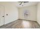 Simple bedroom with modern ceiling fan, grey vinyl wood flooring, and neutral paint at 3820 Wiggins Bay St # 201, Las Vegas, NV 89129