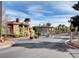 Community's gated entrance, featuring palm trees and professional landscaping at 3820 Wiggins Bay St # 201, Las Vegas, NV 89129