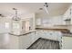 Updated kitchen with white cabinetry, modern fixtures, and breakfast bar offers great space at 3820 Wiggins Bay St # 201, Las Vegas, NV 89129