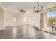 Bright, open living area features modern light fixture, balcony, and updated ceiling fan at 3820 Wiggins Bay St # 201, Las Vegas, NV 89129