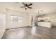 Open-concept living area boasts new wood flooring and a modern chandelier and ceiling fan at 3820 Wiggins Bay St # 201, Las Vegas, NV 89129