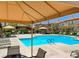 A shared pool is surrounded by lounge chairs and shaded seating areas at 3820 Wiggins Bay St # 201, Las Vegas, NV 89129