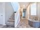 Inviting entryway features stylish tile floors, staircase, and neutral decor at 4376 Latitude Valley Ct, North Las Vegas, NV 89084