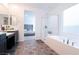 Bright main bathroom with double sinks, a soaking tub and a glass enclosed shower at 4376 Latitude Valley Ct, North Las Vegas, NV 89084