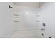 Bathroom featuring a bathtub with shower, white walls and recessed shelving at 439 Royal Bridge Dr, Las Vegas, NV 89178