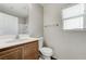 Bathroom features a vanity sink, white toilet, and window for natural light at 439 Royal Bridge Dr, Las Vegas, NV 89178