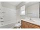 Bright bathroom features a shower-tub combo and wood vanity with solid surface counter at 439 Royal Bridge Dr, Las Vegas, NV 89178
