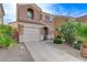 Charming two-story home with a well-manicured front yard, two-car garage, and ample greenery enhancing curb appeal at 439 Royal Bridge Dr, Las Vegas, NV 89178