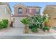 Charming two-story home with a well-manicured front yard and attached garage at 439 Royal Bridge Dr, Las Vegas, NV 89178