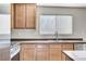 Close-up of the kitchen featuring modern appliances, wood cabinets, and a stainless steel sink at 439 Royal Bridge Dr, Las Vegas, NV 89178