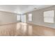 Bright and airy living room with wood flooring and sliding glass doors at 439 Royal Bridge Dr, Las Vegas, NV 89178