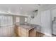 Open-concept living room featuring hardwood floors, an island, and stairs at 439 Royal Bridge Dr, Las Vegas, NV 89178