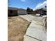View of the side of a home showing a long concrete driveway leading to the garage at 45 Logan Ct, Las Vegas, NV 89110