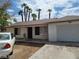 Modest one-story home with brick accents, covered front porch, and a single-car attached garage at 45 Logan Ct, Las Vegas, NV 89110