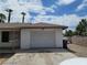 View of the exterior of the home showing the one car garage with a white garage door at 45 Logan Ct, Las Vegas, NV 89110