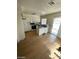 Open kitchen featuring white cabinets, essential appliances, an island, and a sliding glass door at 45 Logan Ct, Las Vegas, NV 89110