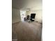 Spacious living room featuring neutral carpet, ample natural light, and a ceiling fan at 45 Logan Ct, Las Vegas, NV 89110