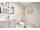 Modern bathroom showcasing a sleek vanity, toilet, and tiled shower with a built-in niche at 4558 Sheppard Dr, Las Vegas, NV 89122