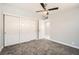 Cozy bedroom featuring plush carpet, neutral walls, and a ceiling fan for added comfort at 4558 Sheppard Dr, Las Vegas, NV 89122