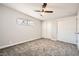 Bright bedroom featuring soft gray carpet, ample closet space and a ceiling fan at 4558 Sheppard Dr, Las Vegas, NV 89122