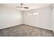 Well-lit bedroom with soft gray carpet, a ceiling fan, and a window at 4558 Sheppard Dr, Las Vegas, NV 89122