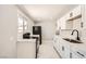 Bright kitchen featuring white cabinets and modern black appliances at 4558 Sheppard Dr, Las Vegas, NV 89122