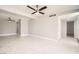 Spacious living room features new white tile flooring and ceiling fans for comfortable living at 4558 Sheppard Dr, Las Vegas, NV 89122