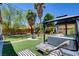 Landscaped backyard oasis with hot tub, lounge chairs, and string lights for serene outdoor living at 4615 Stearman Dr, North Las Vegas, NV 89031