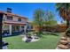 Well-maintained backyard with an extended covered patio, seating area, and a relaxing hammock at 4615 Stearman Dr, North Las Vegas, NV 89031