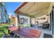 Covered backyard patio complete with dining area, bbq, lounge area, and hot tub at 4615 Stearman Dr, North Las Vegas, NV 89031