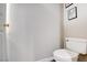 Powder room featuring a white toilet and framed prints at 4615 Stearman Dr, North Las Vegas, NV 89031