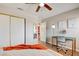 Bright bedroom featuring hardwood floors, a desk, and a modern ceiling fan at 4615 Stearman Dr, North Las Vegas, NV 89031